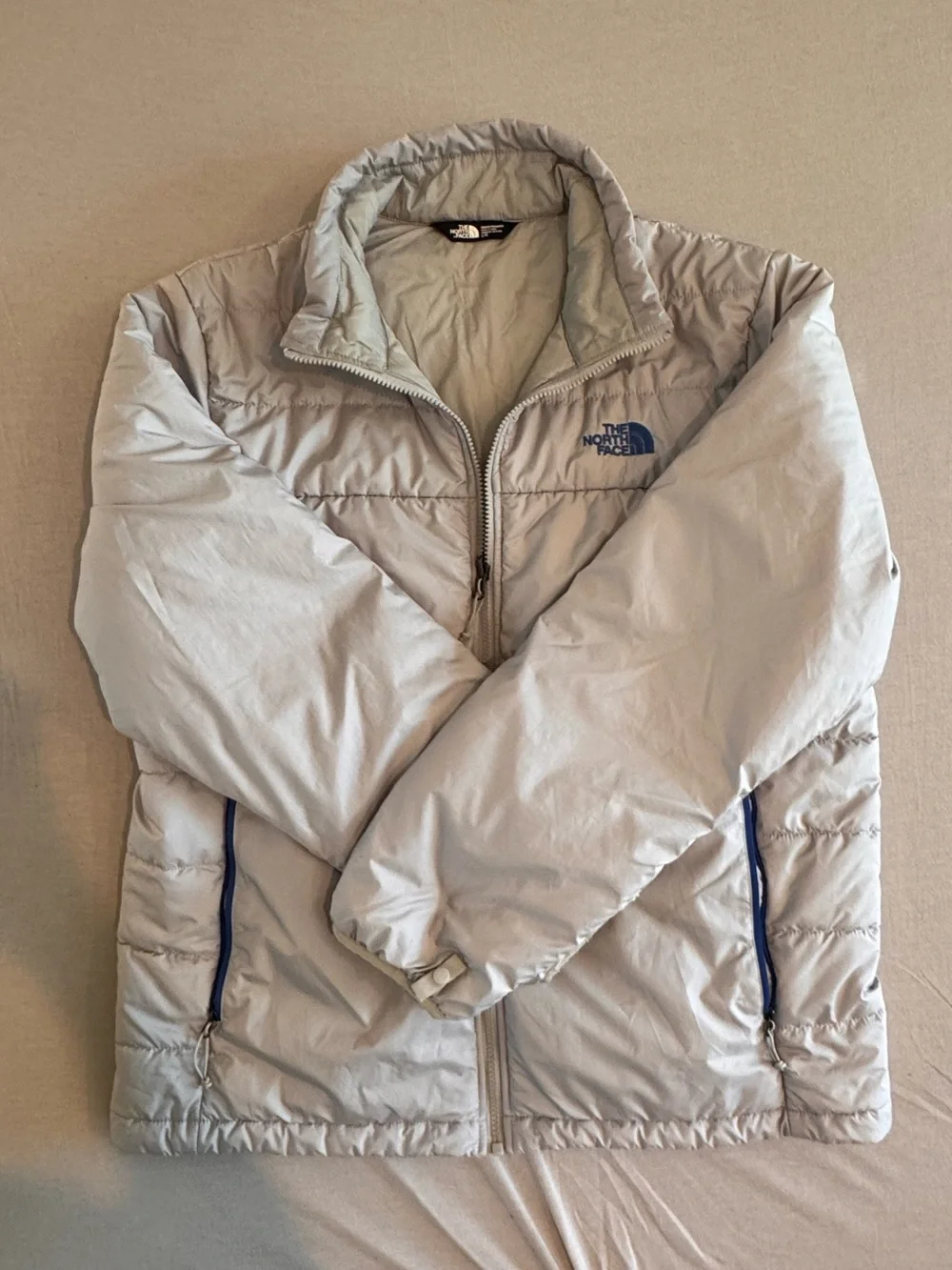 The North Face Light Gray Men's Puffer Jacket with Blue Accents